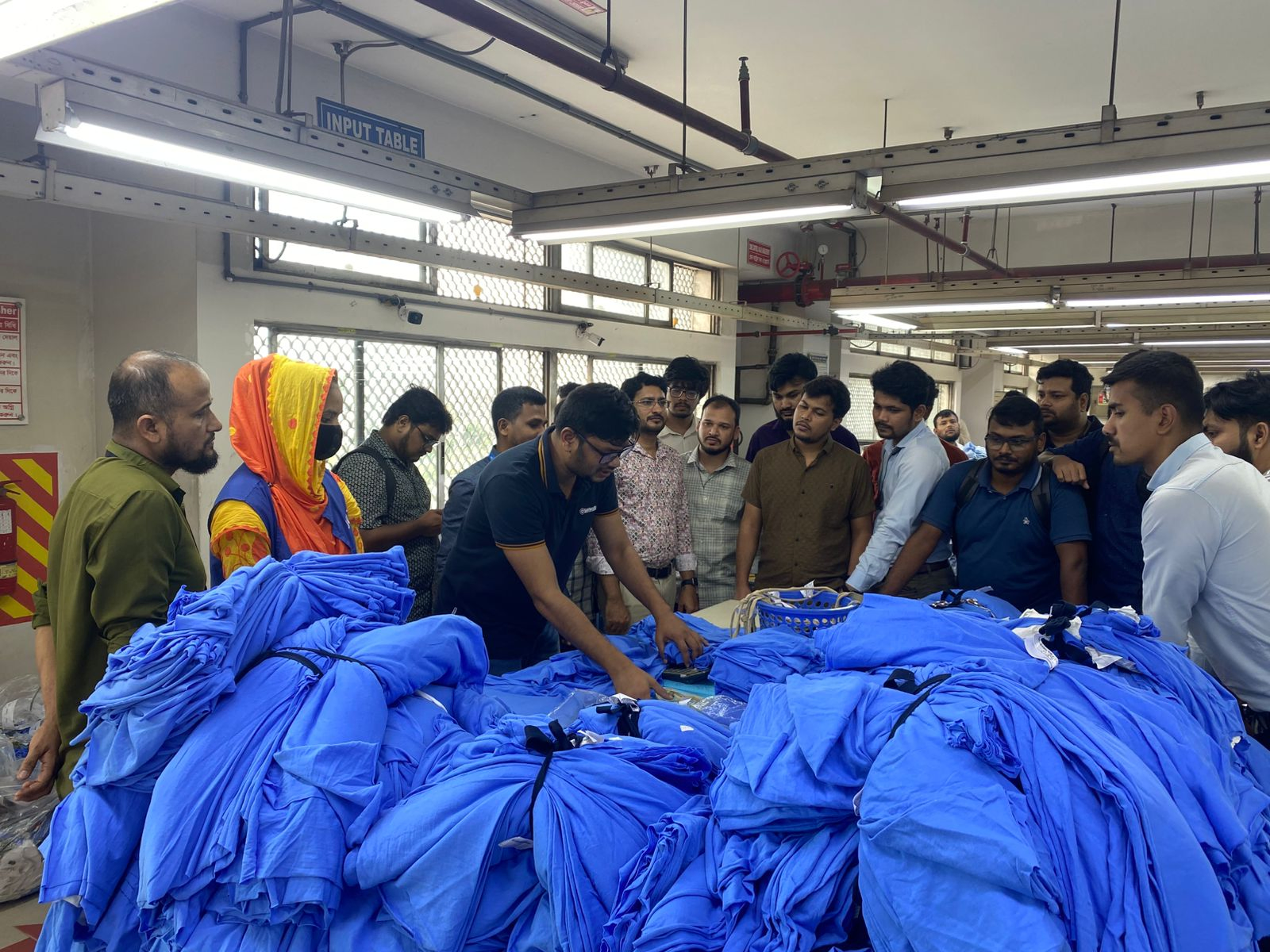 Team walking through garment production line